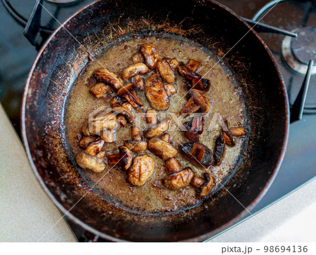 beautiful fried mushrooms champignon in background cast iron pan 98694136