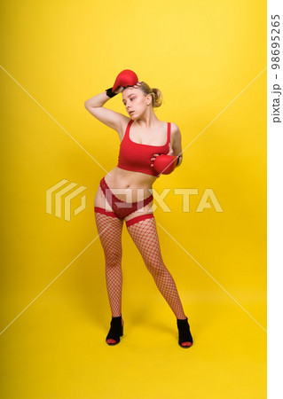 Seductive confident female boxer with gloves studio, sporty woman posing looking at camera. Seductive confident female boxer with gloves studio, sporty woman posing looking at camera. 98695265