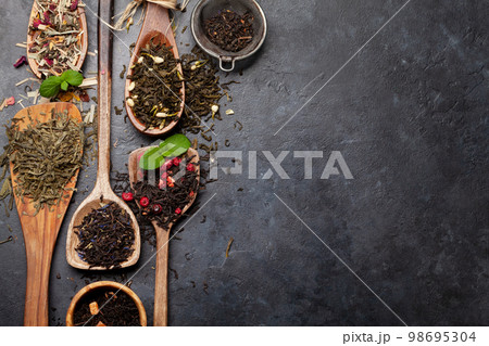 Various dried tea in wooden spoons Various dried tea in wooden spoons 98695304