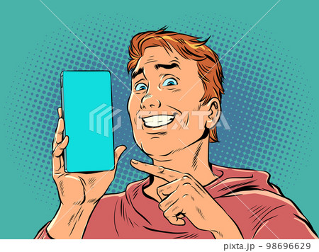 A man with red hair smiles and points to the phone. Product demonstration or offer on smartphone. The joy of a perfect purchase. Pop Art Retro 98696629