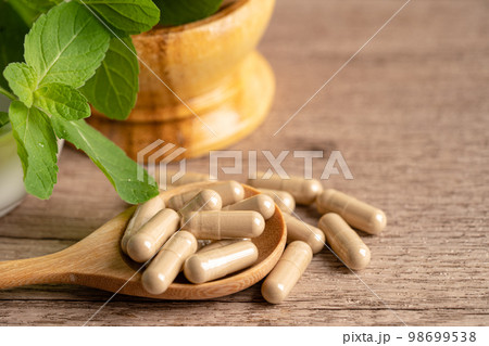 Alternative medicine herbal organic capsule drug with herbs leaf natural supplements for healthy good life. Alternative medicine herbal organic capsule drug with herbs leaf natural supplements for healthy good life. 98699538