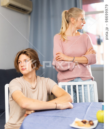 Portrait of unhappy son after discord with mother 98699979