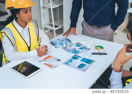 Engineers and competent employer discussing together with tablet in the office. Engineers and competent employer discussing together with tablet in the office. 98700639