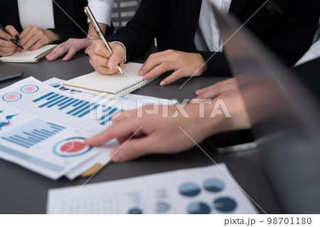 Closeup focus on BI dashboard with office worker in harmony office. 98701180