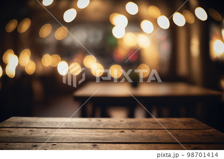 Empty wood table for product display in blur background of restaurant at night Empty wood table for product display in blur background of restaurant at night 98701414
