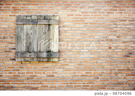 old wooden window on brown brick wall background old wooden window on brown brick wall background 98704096