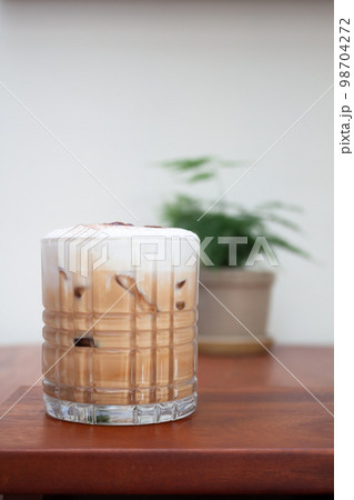 Iced coffee with micro foam in coffee shop Iced coffee with micro foam in coffee shop 98704272
