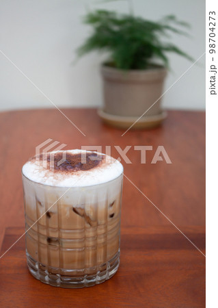 Iced coffee with micro foam in coffee shop 98704273