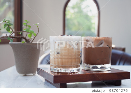 Iced coffee with micro foam in coffee shop Iced coffee with micro foam in coffee shop 98704276
