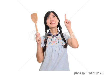 Portrait of beautiful young asian woman smile in denim dress with spatula on white background 98710470