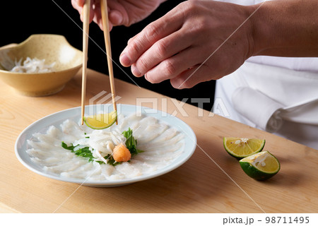 とらふぐの薄造りを盛り付ける板前 とらふぐの薄造りを盛り付ける板前 98711495