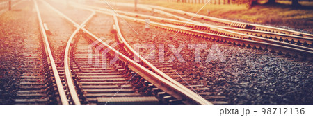 Panoramic view of the crossing railway in sunset in summer. Panoramic view of the crossing railway in sunset in summer. 98712136
