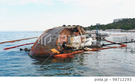 Broken rusty oil tanker ship in the shallow water after the wreck. Close up view from the drone. 98712293