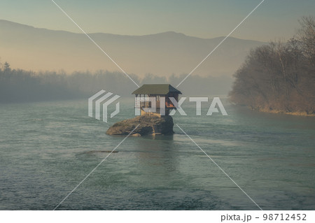 Lonely house on Drina river in Serbia 98712452