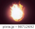 燃え上がる火の玉と黒背景 98712692