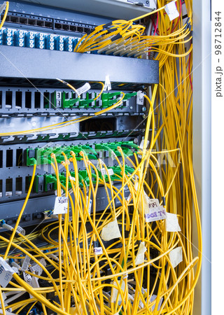fiber optic cables plugged in network switch panel inside data center fiber optic cables plugged in network switch panel inside data center 98712844