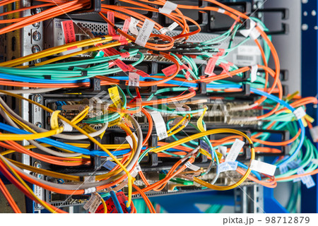 detail of server rack with fiber optic cables attached to front panel switch ports detail of server rack with fiber optic cables attached to front panel switch ports 98712879