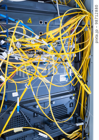 yellow fiber optic cables plugged in network switch 98712880