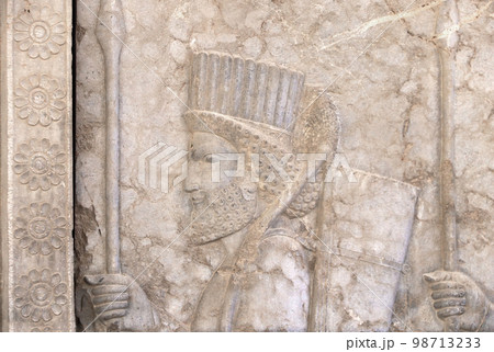 Ancient wall with bas-relief with assyrian warrior with spear, Persepolis, Iran 98713233