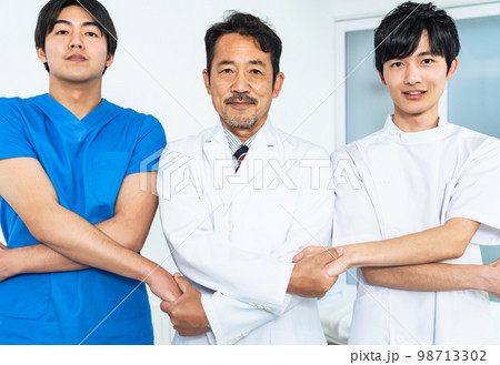 手を繋ぐ医療従事者のグループ 98713302