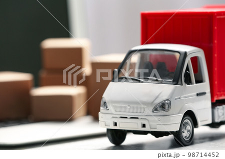 Toy truck near laptop on table. Logistics and wholesale concept 98714452