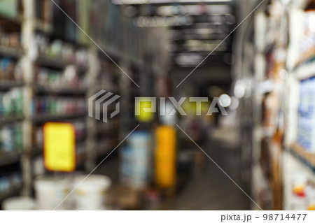Blurred view of storage stands with different building materials in wholesale warehouse 98714477