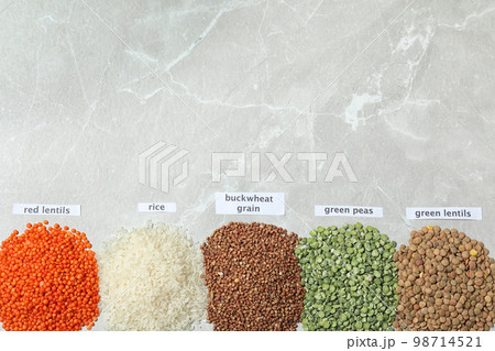 Flat lay composition with different types of legumes and cereals on grey marble table, space for text. Organic grains Flat lay composition with different types of legumes and cereals on grey marble table, space for text. Organic grains 98714521