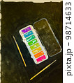 Digital watercolor art kids paint box open with brushes on black background 98714633