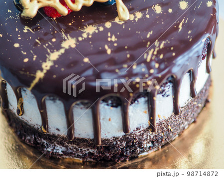dark chocolate frosted drip cake with best wishes topping written in italian dark chocolate frosted drip cake with best wishes topping written in italian 98714872