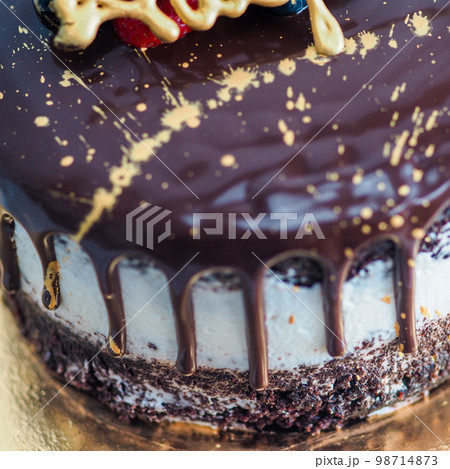 dark chocolate frosted drip cake with best wishes topping written in italian dark chocolate frosted drip cake with best wishes topping written in italian 98714873