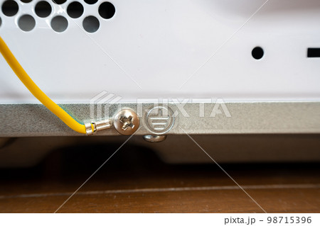 Ground wire or earth wire behind a Japanese model microwave oven. 98715396