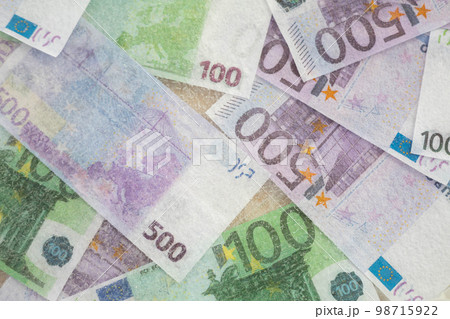 Blurred photo of one hundred and five hundred euros are defrosted in ice. The European cash currency is frozen. Blurred photo of one hundred and five hundred euros are defrosted in ice. The European cash currency is frozen. 98715922
