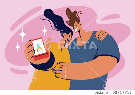 Smiling engaged couple show engagement ring 98717715