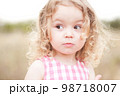 Cute baby girl 2-3 year old posing outdoors. Looking away. Childhood. 98718007