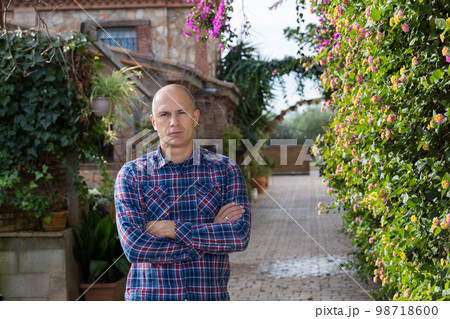 Confident man in yard on rural house Confident man in yard on rural house 98718600
