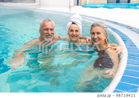 Group of seniors in the swimming pool looking happy and enjoyed Group of seniors in the swimming pool looking happy and enjoyed 98719421