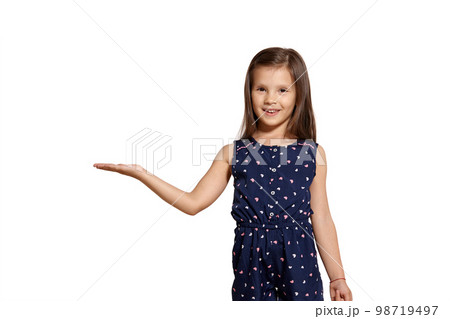 Close-up studio shot of beautiful brunette little girl posing isolated on white studio background. 98719497