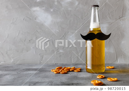 Bottle of beer with moustache. Movember. Concept of father's day, bachelor party. Bottle of beer with moustache. Movember. Concept of father's day, bachelor party. 98720015