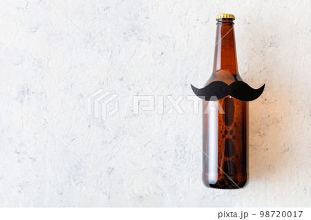 Bottle of beer with moustache. Movember. Concept of father's day, bachelor party. Bottle of beer with moustache. Movember. Concept of father's day, bachelor party. 98720017