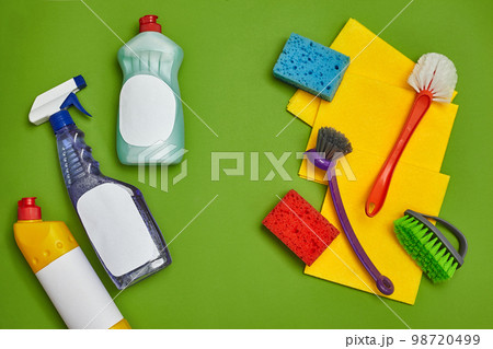 Detergents and cleaning accessories on a green background. Housekeeping concept. Detergents and cleaning accessories on a green background. Housekeeping concept. 98720499