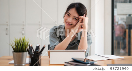 Joyful businesswoman sitting at desk looking at laptop screen talking with friend make informal video call. 98721940