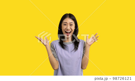 Asian woman acting shocked or surprised isolated on a white background, Looking camera, Concept acts according to the emotions and feelings of excitement and shock, Yellow background, Copy space. Asian woman acting shocked or surprised isolated on a white background, Looking camera, Concept acts according to the emotions and feelings of excitement and shock, Yellow background, Copy space. 98726121