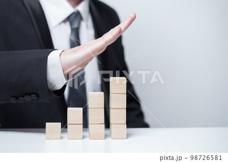 Wooden blank cubes, business growth success goal concept, businessman pointing up 98726581