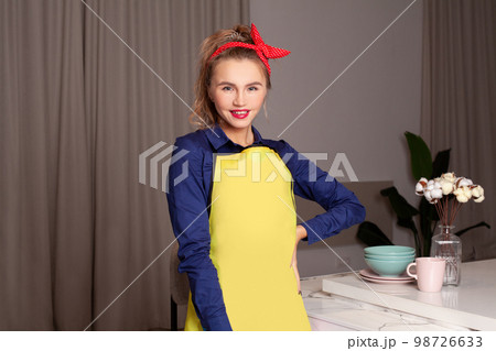 Happy smiling woman in blue and yellow dress. Pinup woman with trendy makeup. 98726633