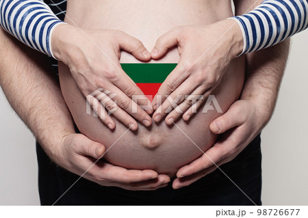 Bulgarian family concept. Man embracing pregnant woman belly and heart with flag of Bulgaria 98726677