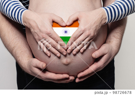 Indian family concept. Man embracing pregnant woman belly and heart with flag of India Indian family concept. Man embracing pregnant woman belly and heart with flag of India 98726678