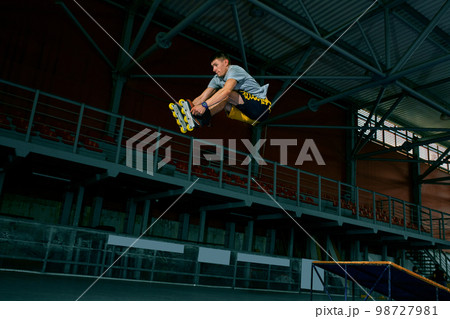 The man performs a trick. Jump. Indoor training 98727981