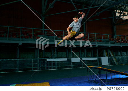 The man performs a trick. Jump. Indoor training 98728002