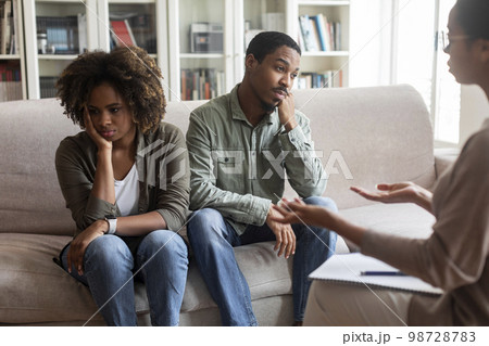 Frustrated married black couple attending family therapist 98728783