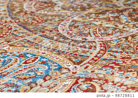Oriental woolen carpet with traditional colorful ornaments. Close up Oriental woolen carpet with traditional colorful ornaments. Close up 98728811